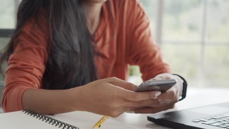 Close-up-hands-asian-businesswoman-using-smartphone.