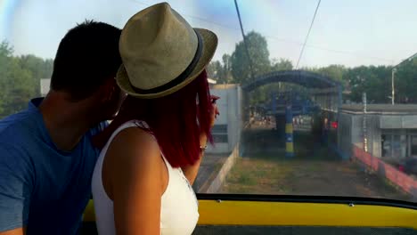 Couple-on-cable-car-going-down-on-the-ground