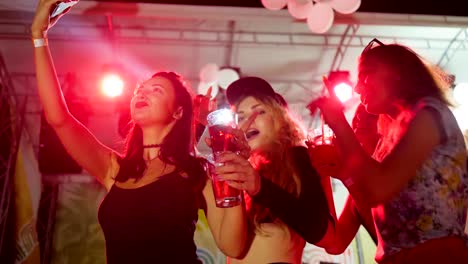 self-photo-With-bright-drink-at-nightclub,-sexy-women-dancing-at-night-party-with-alcohol,-girls-dance-with-beverage