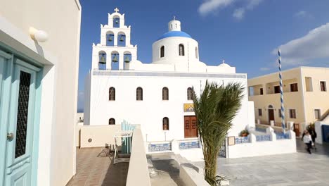 Orthodox-church-in-white-against-blue-clear-sky-on-Santorini,-Greece,-religion