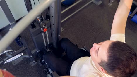 Top-view-of-a-weights'-lifting-process-by-a-handicapped-man-in-a-wheelchair