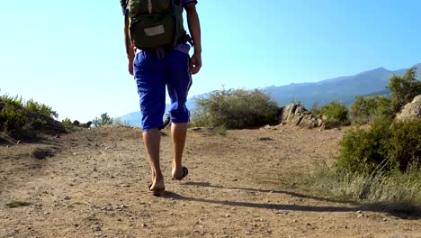 A-tourist-with-a-backpack-in-the-mountains.