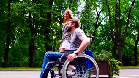 Young-disable-man-walking-in-the-park-with-his-wife