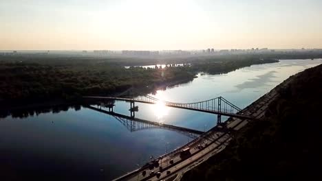 Kiev-(Kiyv)-Ukraine-capital.-River-Dnepr-(Dnipro)-Parkivyi-Bridge-to-Truhaviv-island-Aerial-drone-video-footage-from-above.-Sunrise-time