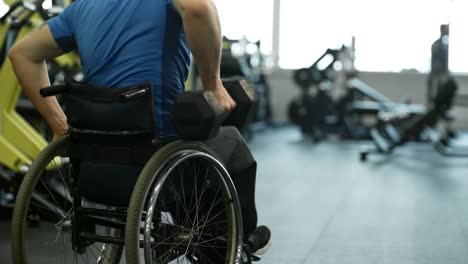 Unrecognizable-Man-in-Wheelchair-Doing-One-Arm-Rows