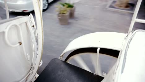 White-coach-is-riding-down-the-street.-Wedding.-Asphalt.-Wheels-close-up.