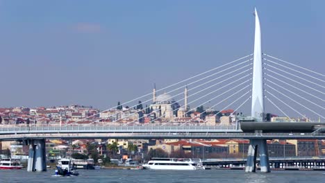 Golden-Horn-Metro-Bridge-in-Istanbul,-steamboats-sailing-by,-tourism-in-Turkey