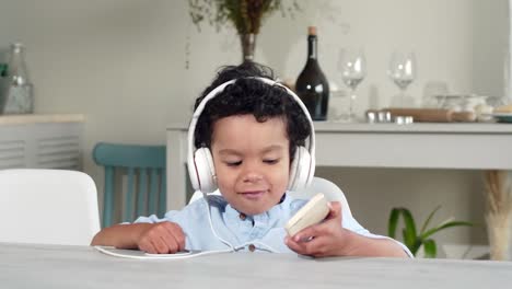 Little-African-Kid-Listening-to-Music-on-Smartphone