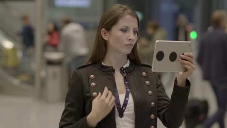 Good-looking-Caucasian-lady-texting-messages-and-sending-data-on-digital-tablet