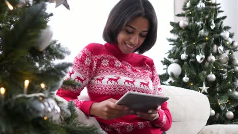 Teenage-girl-using-digital-tablet-during-Christmas