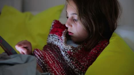 Little-girl-studying-and-doing-homework-at-home-with-tablet.