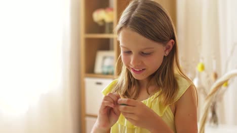 girl-removing-wrapper-of-chocolate-easter-egg