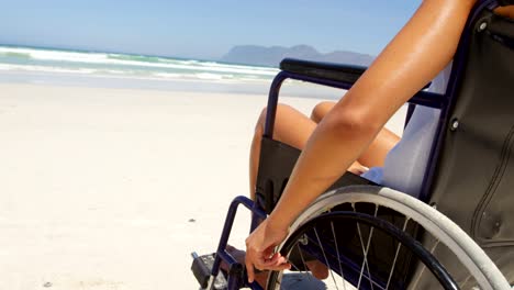 Disabled-woman-sitting-on-wheelchair-at-beach-4k