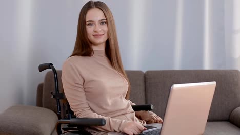 Young-disabled-woman-working-at-home-with-laptop