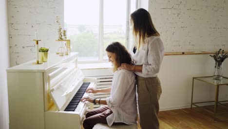 Girlfriends-learning-piano-playing-at-home