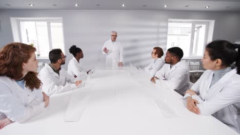 Professor-Explaining-Task-to-Students-in-Futuristic-Digital-Classroom