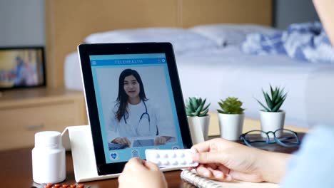 4K.-sick-woman-use-video-conference,-make-online-consultation-with-doctor-via-tablet,-patient-ask-doctor-about-illness-and-medication-via-video-call.-Telehealth,-Telemedicine-and-online-hospital