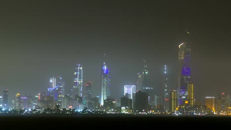 Skyline-with-Skyscrapers-night-timelapse-in-Kuwait-City-downtown-illuminated-at-dusk.-Kuwait-City,-Middle-East