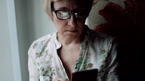 Woman-watching-something-on-the-smartphone-screen