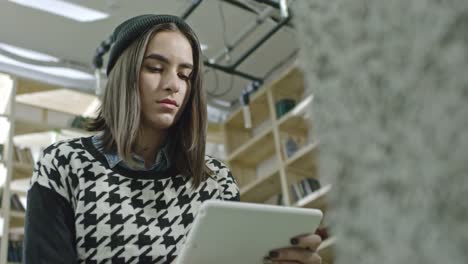 Hipster-Girl-Sitting-in-Office-with-Tablet