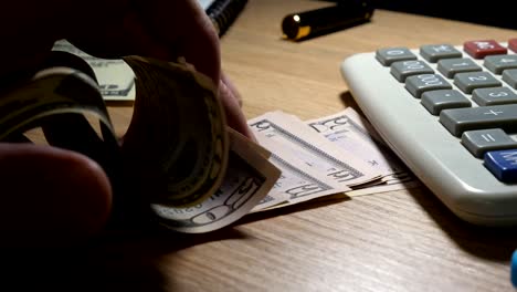 Close-up-of-Man’s-hands-counting-dollar-bills.-Slow-motion.