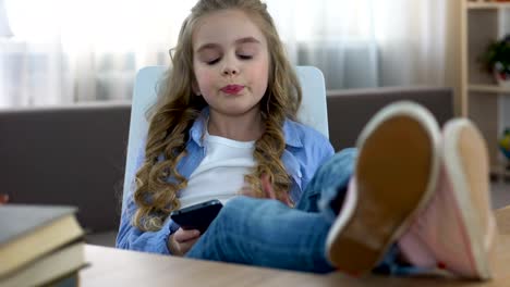 Girl-texting-message-on-smartphone-sitting-on-chair,-social-networks,-addiction