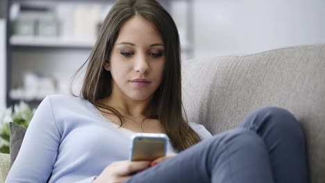 Smiling-girl-texting-with-her-mobile