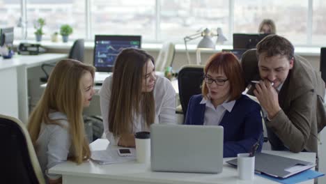 Joyous-Business-Team-Listening-to-Female-Manager