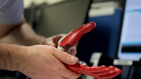 Close-up-of-male-engineer-working-on-bionic-hand