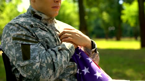 Armed-forces-hero-holding-american-flag,-memorial-service-for-war-victims