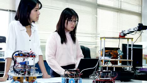 Engineering-collaborating-on-develop-of-robot-in-laboratory.-4K-Resolution.