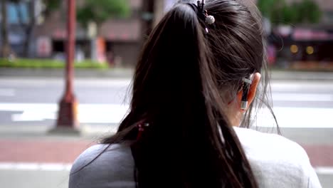 Hearing-loss-child-wearing-a-hearing-aid.At-the-bus-stop.