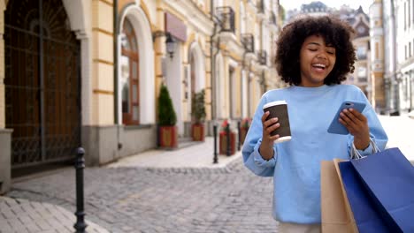 Cute-mixed-race-girl-busy-with-cellphone-on-street