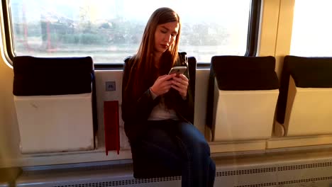 Woman-in-train-using-smart-phone