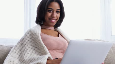 Teenage-girl-with-laptop-on-sofa