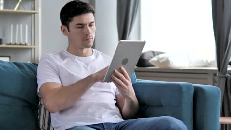 Young-Man-Using-Tablet-at-Workplace