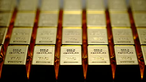 Gold-bars-are-taken-away-from-a-black-surface---Stop-Motion