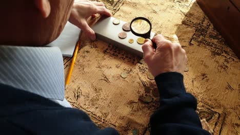 Coin-Evaluator.-The-collector-of-coins.-The-man-considers-ancient-coins.