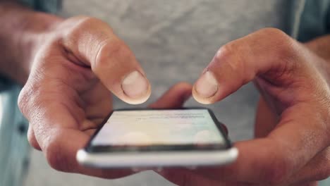 Midsection-Of-Freelancer-Using-Cellphone-In-cafe