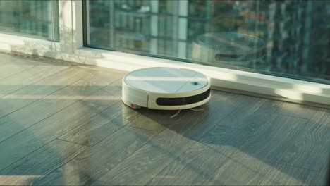 Close-up-of-the-robotic-vacuum-cleaner-riding-around-and-cleaning-up-apartments