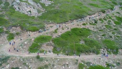 A-group-of-people-running-down-the-mountainside.-The-Mountains-Of-The-Caucasus.-Russia