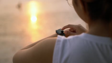 using-smartwatch-at-sunset-slowmotion