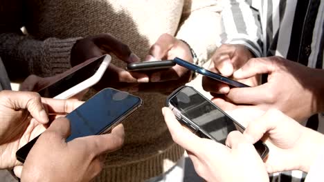 High-angle-view-of-young-people-using-smartphones