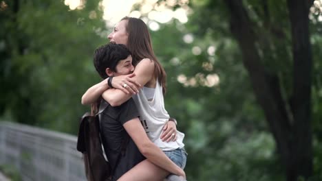 The-lesbian-sit-on-a-fence-and-hugs-her-girlfriend