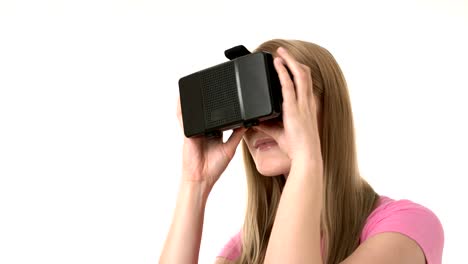 Beautiful-attractive-young-woman-in-pink-t-shirt-using-her-VR-glasses.-Isolated-white-background