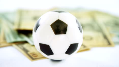 Football-and-dollar-against-white-background-4k