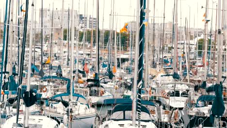 Lot-of-beautiful-white-stylish-yachts-moored-in-a-harbor-or-bay-in-Barcelona