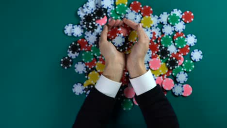 Happy-businessman-showing-chips-before-camera,-casino-player-winning-game