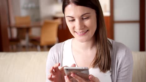 Woman-at-home-using-mobile.-Young-female-professional-having-conversation-on-smartphone,-browsing