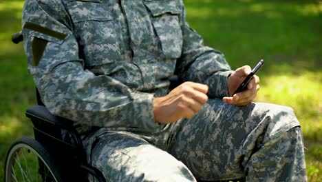 Handicapped-serviceman-scrolling-smartphone-app,-job-search,-rehabilitation